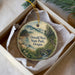 A round ornament with a scenic landscape of Oswald West State Park, Oregon, displayed in a box with a white tissue paper lining.