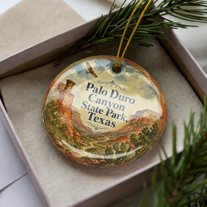 A decorative ornament in a box, featuring a scenic image of the Palo Duro Canyon State Park in Texas.