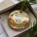 A decorative ornament in a box, featuring a scenic image of the Palo Duro Canyon State Park in Texas.