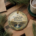 A decorative ornament featuring the text "Palouse Falls State Park, Washington" and an illustration of a waterfall surrounded by pine trees.