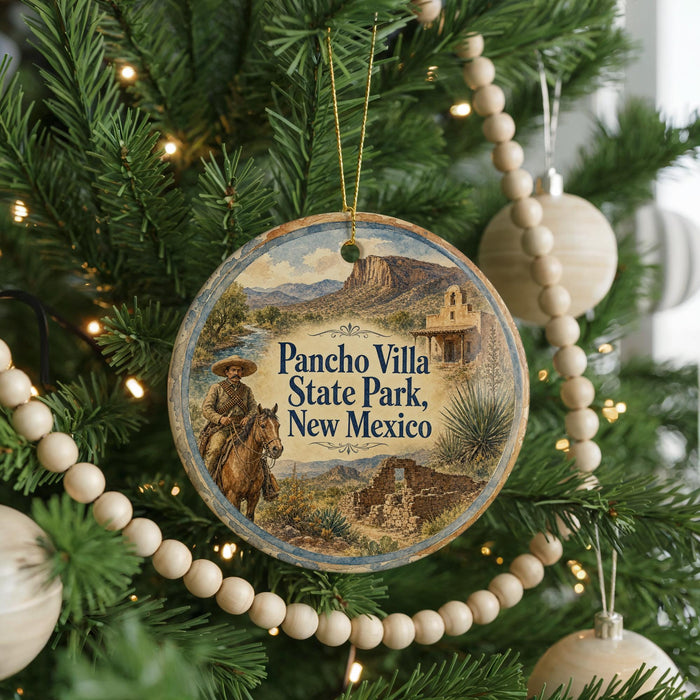 A circular ornament hanging on a Christmas tree, featuring a cowboy on horseback and the text "Pancho Villa State Park, New Mexico".