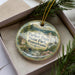 A decorative ornament in a box, featuring a scenic image of the park and a text that reads "Parker Dam State Park, Pennsylvania".