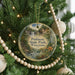 A round ornament on a Christmas tree, featuring a scenic image of Patison State Park, Wisconsin.