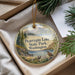 A decorative ornament with a scenic landscape of Pearry Lake State Park, Washington, featuring a bird perched on a rock and surrounded by pine trees.