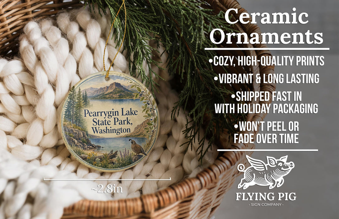 Ceramic ornaments, featuring a scenic image of Pearyrgin Lake State Park, Washington, with a bird perched on a tree branch. The ornaments are described as cozy, high-quality prints, vibrant, and long-lasting, and are shipped fast in holiday packaging. They are not to be peeled or faded over time.