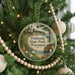 A round ornament on a Christmas tree, featuring a lighthouse and a scenic landscape, with the text "Peninsula State Park, Wisconsin" displayed on it.