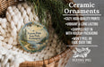 Ceramic ornaments, featuring a round ornament with a scenic landscape design, are displayed in a woven basket.