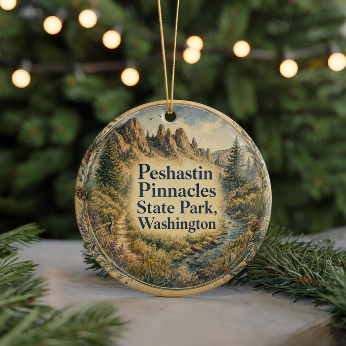A circular ornament with a scenic mountain landscape and text, hanging on a string.