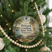 A round ornament hanging on a Christmas tree, featuring a scenic image of Pickwick Landing State Park in Tennessee.