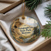 A decorative ornament with a scenic landscape of Pictograph Cave, State Park, Montana, hanging from a string.
