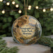 A circular ornament with a scenic landscape depicting Pictograph Cave in Montana, surrounded by pine trees and a river.