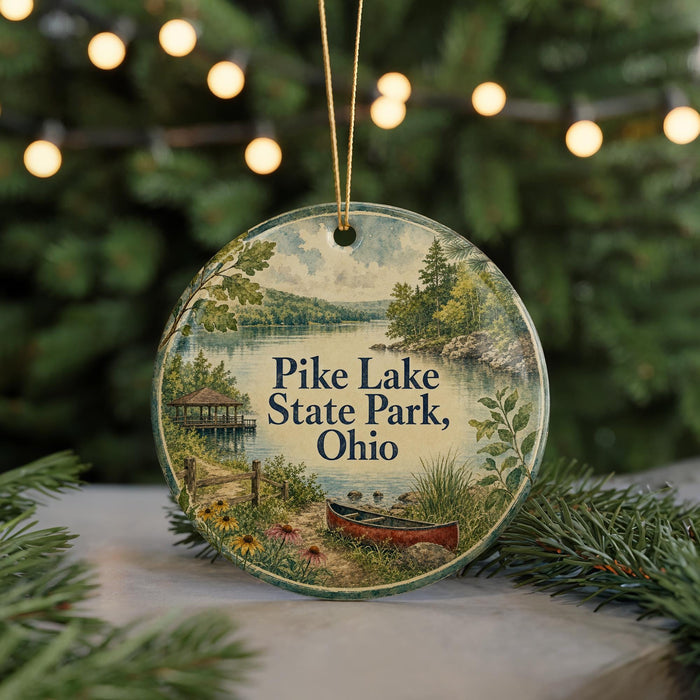 A round ornament with a scenic landscape of Pike Lake State Park, Ohio, featuring a canoe on the shore and a dock in the background.