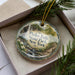 A decorative ornament with a scenic image of Pixley Falls State Park in New York, featuring a waterfall and lush greenery.