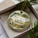 A decorative ornament in a box, featuring a scenic image of Platte River State Park, Nebraska.