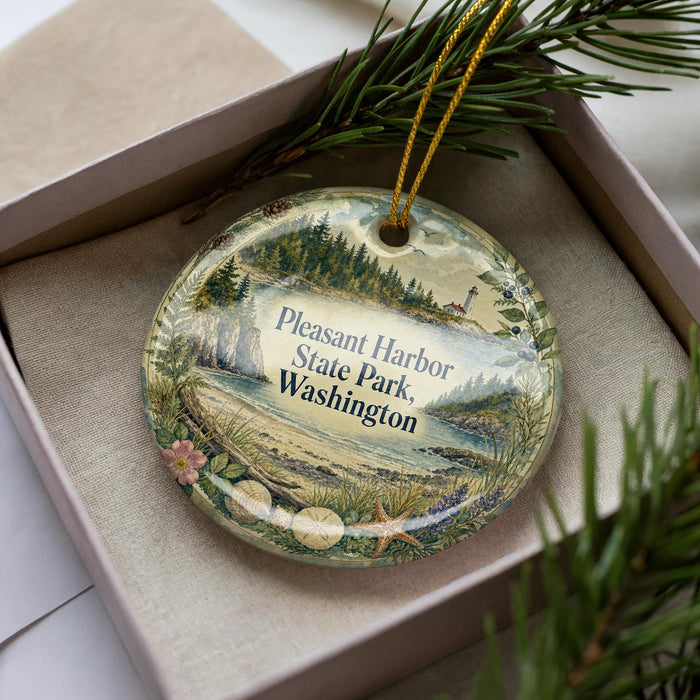 A decorative ornament with a scenic image of Pleasant Harbor State Park in Washington, featuring a lighthouse and a river.