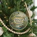 A round ornament hanging on a Christmas tree, featuring a scenic image of Radnor Lake State Park in Tennessee.