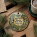 A circular ornament with a scenic image of Raymond B. Winter State Park, Pennsylvania, hanging on a wooden surface.