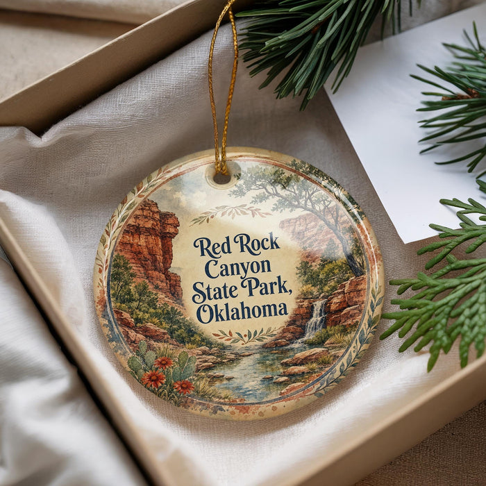 A decorative ornament with a scenic image of the Red Rock Canyon State Park in Oklahoma, featuring a waterfall and desert landscape.