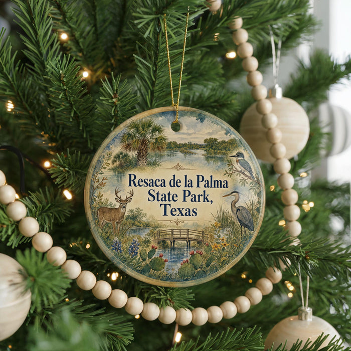 A round ornament hanging on a Christmas tree, featuring a scenic image of a park and wildlife.