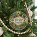 A round ornament hanging on a Christmas tree, featuring a scenic image of Ridley Creek State Park in Pennsylvania.