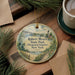 A round ornament with a scenic illustration of Robert Moses State Park (Thousand Islands), New York, hangs on a wooden surface.