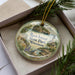 A decorative ornament featuring a scenic landscape of Rock Island State Park, Wisconsin, with a lighthouse and surrounding natural scenery.