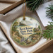 A decorative ornament with a scenic image of Rock Island State Park in Wisconsin, featuring a lighthouse, trees, and a bird.
