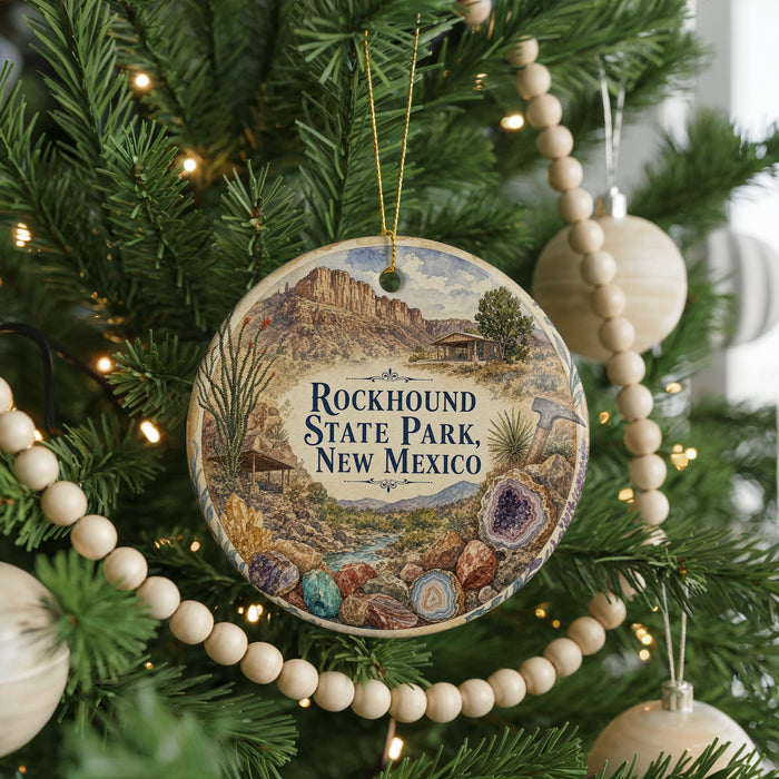 A round ornament hanging on a Christmas tree, featuring an illustration of the Rockhound State Park in New Mexico.