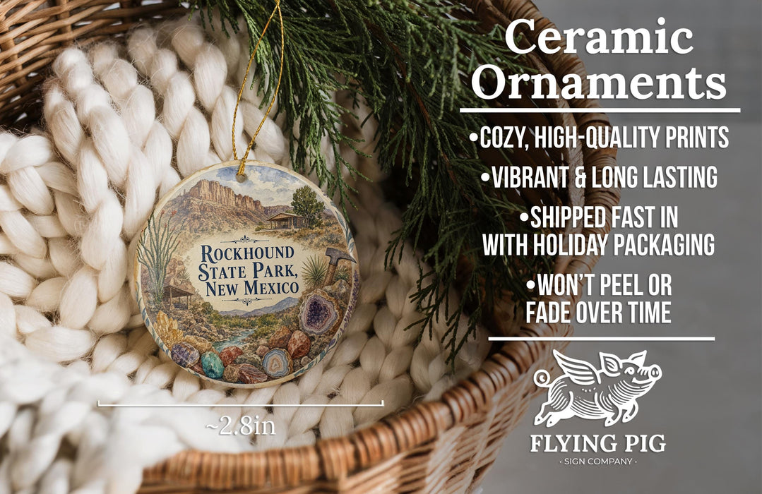 Ceramic ornaments, featuring a ceramic ornament with a desert landscape and a ceramic ornament with a bird, both placed in a woven basket.