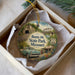 A decorative ornament in a white box, featuring a vintage car and a scenic landscape with Route 66 and Route 66 State Park in Missouri.