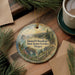 A round ornament with a scenic landscape of mountains, forests, and a river, featuring the text "Samuel H. Boardman State Scenic Corridor, Oregon".