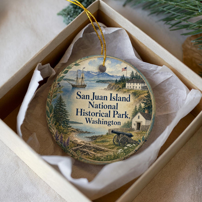A decorative ornament in a box, featuring a scenic image of San Juan Island National Historical Park in Washington.