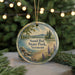 A round ornament with a scenic image of Sand Bar State Park, Vermont, featuring a beach, mountains, and pine trees.