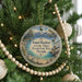 A round ornament hanging on a Christmas tree, featuring a scenic image of Lake Tahoe and Nevada State Park.