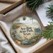 A decorative ornament in a box, featuring a scenic image of Sea Rim State Park, Texas, with a lighthouse and various wildlife elements.