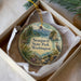 A decorative ornament in a white box, featuring a scenic landscape with mountains, trees, and a bird, along with the text "Sequest State Park, Washington".