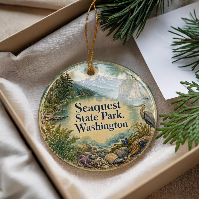 A decorative ornament with a scenic landscape of Sequest State Park, Washington, featuring a bird, pine trees, and mountains.