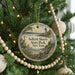 A round ornament on a Christmas tree, featuring a lighthouse and a seagull, with the text "Sellkirk Shores State Park, New York" printed on it.