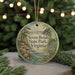 A circular ornament with a scenic landscape of Seven Bends State Park, Virginia, featuring a bird perched on a branch and surrounded by trees and water.