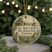 A round ornament with a picture of a man and a landscape, surrounded by Christmas lights and greenery.