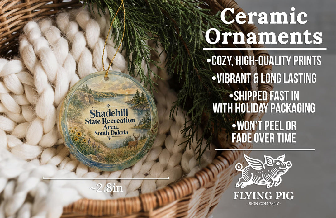 Ceramic ornaments, featuring a scenic landscape of Shaddell State Recreation Area, South Dakota, hanging from a wicker basket.