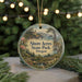 A round ornament with a scenic landscape of a forest, a lighthouse, and a body of water, hanging from a string.