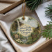 A round ornament with a scenic image of Silver Falls State Park, Oregon, hanging from a string.
