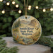 A round ornament with a scenic landscape of Smith River State Park, Montana, featuring a mountain, river, and wildlife.