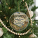 A round ornament hanging on a Christmas tree, featuring a scenic landscape of Snake Creek State Recreation Area in South Dakota.