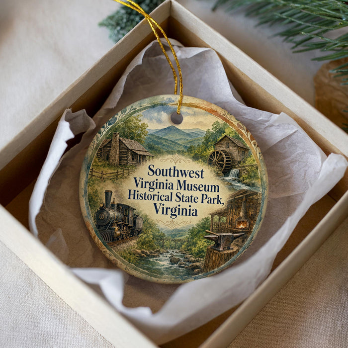 A decorative ornament in a box, featuring illustrations of a train, a cabin, and a waterfall, with the text "Southwest Virginia Museum Historical State Park, Virginia" printed on it.