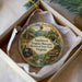 A decorative ornament in a box, featuring illustrations of a train, a cabin, and a waterfall, with the text "Southwest Virginia Museum Historical State Park, Virginia" printed on it.