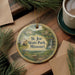 A round ornament with a scenic image of St. Joe State Park, Missouri, hanging on a wooden surface.