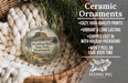 Ceramic ornaments, specifically Steamboat Rock State Park, Washington ornaments, are displayed in a basket with pine branches.