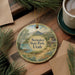 A round ornament with a scenic landscape of Steiner State Park, Utah, featuring mountains, a river, and pine trees.